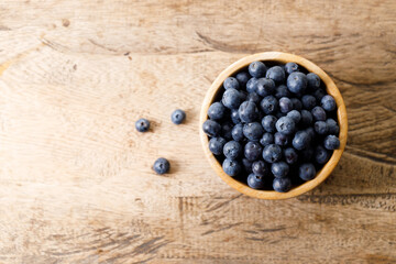 Ripe organic blueberries on wooden table background. Selective focus.