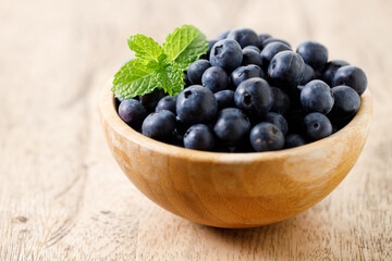 Ripe organic blueberries on wooden table background. Selective focus.