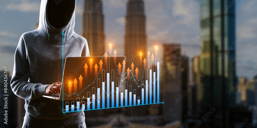 Poster Hacker in hoodie using laptop with growing business graph on blurry city background. Financial growth, hacking and technology concept. Double exposure.