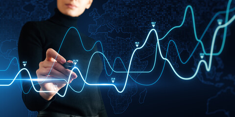 Headless young woman using growing business graph on dark background. Financial growth and...