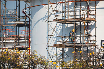 Construction workers installing scaffolding storage tank Oil​ refinery​ and​ plant and tower column of Petrochemistry industry