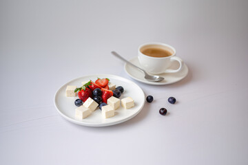 coffee, strawberry, blueberry, feta cheese breakfast