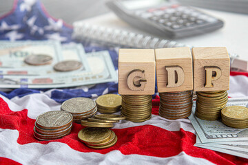 Wooden cubes with the words USA and GDP over the American flag background. Business and growth of GDP, domestic product concept. Top view