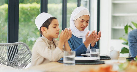 Mother, praying and Muslim family with food to say prayer or dua before Eid dinner on holy month of...