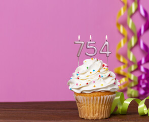 Birthday Cupcake With Candles Lit Forming The Number 754