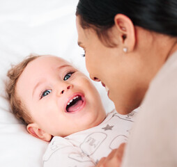 Laugh, portrait and happy baby with mother on a bed for fun, bonding and playing tickle games in...