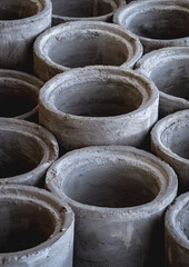 A stack of concrete ring pipes piled and creating a symmetrical arrangement