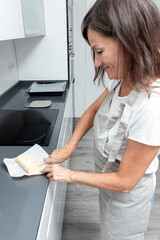 mature woman cutting butter in a kitchen