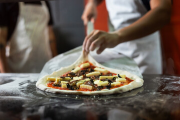 experienced chef - process of making pizza. Professional chef prepares the dough with flour to make pizza or pasta Italian food