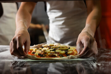 experienced chef - process of making pizza. Professional chef prepares the dough with flour to make pizza or pasta Italian food
