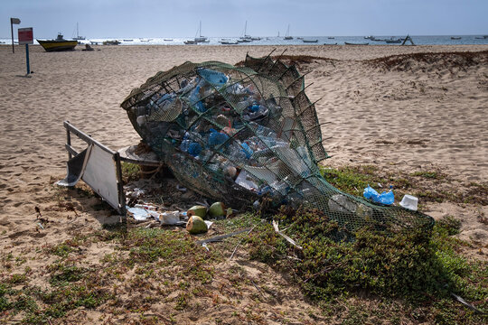 Net in the shape of a Fish full of Plastic Containers and Plastic Waste with extra plastic spilling out, Praia de Santa Maria Beach, Santa Maria, Sal, Cape Verde Islands, Atlantic