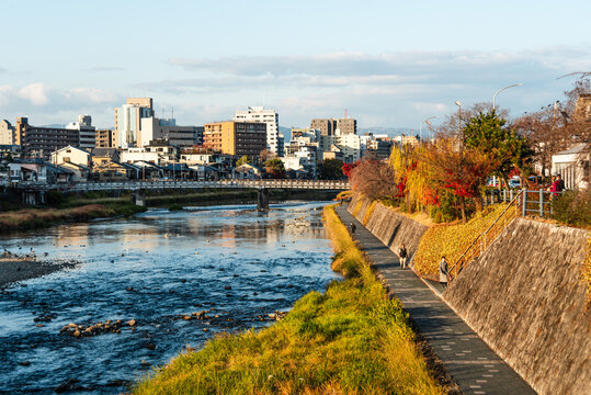 Sunset in Kyoto above the Kamo River walk and city skyline, Kyoto, Honshu