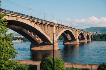 Fototapeta premium Communal bridge over the Yenisei River at beauty sunny summer day in Krasnoyarsk city.