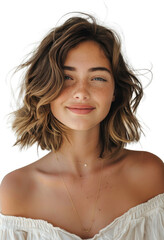 Obraz premium Woman With Short Brown Wavy Hair Smiling Against A White Wall