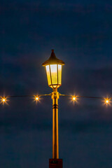 A lamp post and string of lights at the coast at Eastbourne