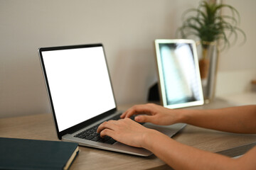 Close up shot of woman hands typing on laptop keyboard working remotely from home