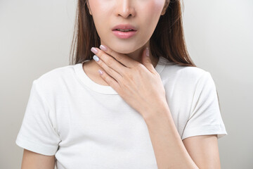 Sickness in inflaming asian young woman, girl use hand check self touch at sore throat, pain...