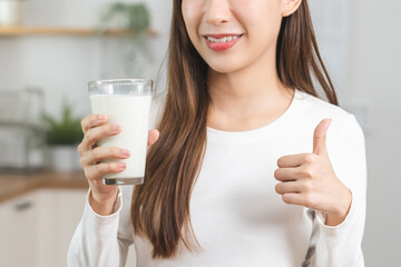 Health care, smile asian young woman, girl showing thumb up, holding glass of fresh, dairy soy milk...