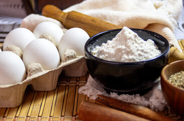 Eggs, flour and flavours for making biscuits. Side view photo