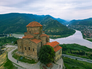  Georgian temple near a river in the green mountains of Georgia - drone photo