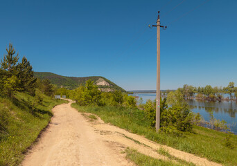Road along the shore between the rocks and the Volga river to Shiryaevo village in Samarskaya Luka...