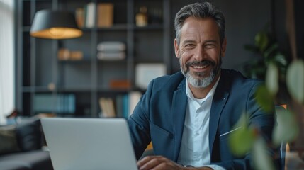 Businessman executive using laptop at desk. Businessman manager working on computer in middle age.