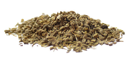 A pile of anise seeds with a white background. .Close-up side view photo of anise seeds with light background. Ingredient for gourmet meals