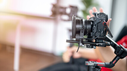 A person is holding a camera with a black lens