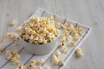 White Buttered Popcorn with Salt in a Bowl, side view. Copy space.