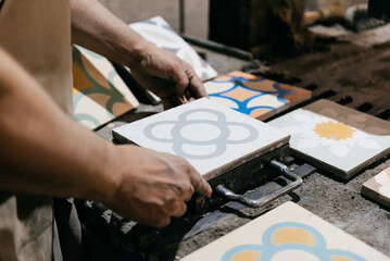 Close-Up of Artisan Working With Cement Tiles in a Workshop in the Afternoon