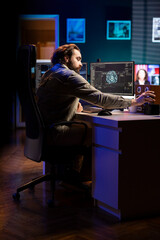Developer inserting disk into PC containing language data models able to create conscient AI. IT...