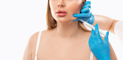 Cosmetologist does injections for lips augmentation and anti wrinkle in the nasolabial folds of a...