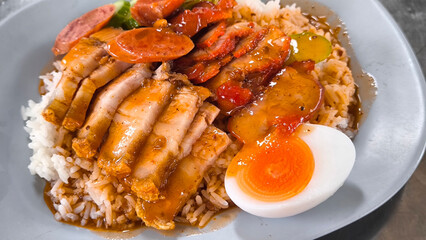 Crispy pork rice on a blue plate on the dining table