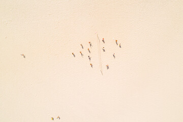 overhead aerial view with drone of people on a beach playing beach volleyball