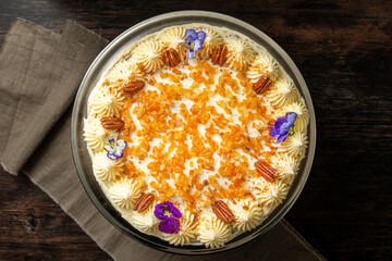 Damascus and pecan cake beautifully decorated on a dark brown background. Naked Cake.