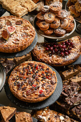 Big table with various cakes, tarts, muffins and pastries. Top view