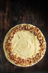 Walnut sponge cake with cream inside. Rustic background