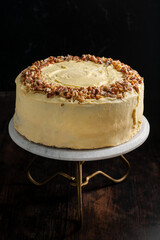 Walnut sponge cake with cream inside. Rustic background