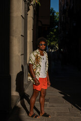 Brazilian Male Model Posing in Urban Setting with Colorful Summer Attire: High-End Fashion Cinematic Lighting