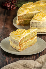 Lemon cake decorated with cream on top, on a rustic wooden table. Sponde cake  
