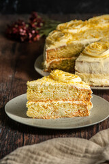 Lemon cake decorated with cream on top, on a rustic wooden table. Sponde cake  