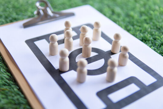 Football tactical clipboard on top of green football field. Football formations, strategy and tactical concept.