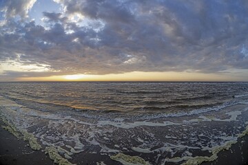 Panoramic picture over the beach of Ouddorp in Holland in the evening during sunset