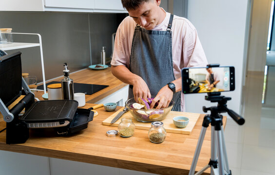 The chef is broadcasting live from workshop how to prepare a grilled eggplants with garlic