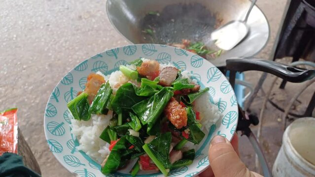 Stir fried kale with crispy pork in oyster sauce. Thai street food called kana moo krob 
