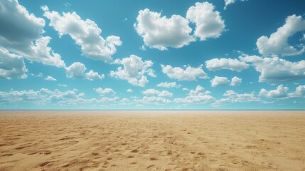 Obraz premium Empty Sandy Beach With Blue Sky and White Clouds on a Sunny Day