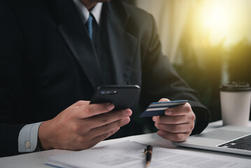 online payment internet hand holding smartphone with card credit transaction.Business financial and banking accounting.