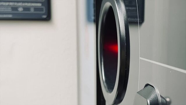 A girl sends aluminum cans and plastic bottles to a recycling machine
