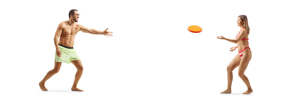 Young woman in bikini throwing a plastic flying disc with a young man