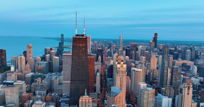 Aerial view golden sunset skyline Chicago. Business city landscape. Yellow reflection skyscraper sunset scene with blue sky. Lights highway and cityscape.